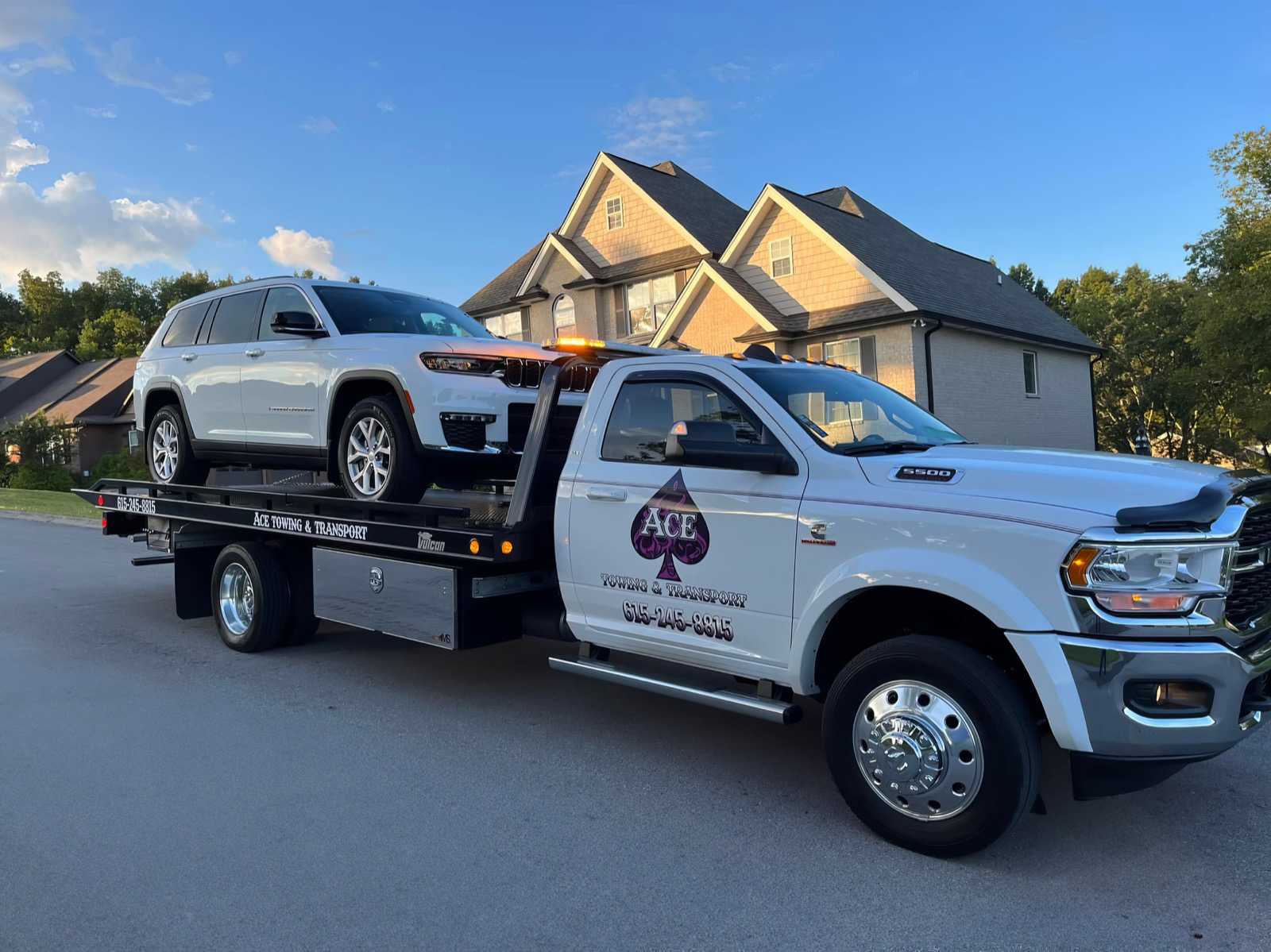 Ace Towing and Transport truck with SUV on top